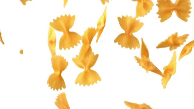 Super slow motion farfalle paste dry falls. On a white background. Filmed on a high-speed camera at 1000 fps. High quality FullHD footage