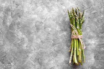 Asparagus. Fresh green asparagus on grey background. Top view copy space.
