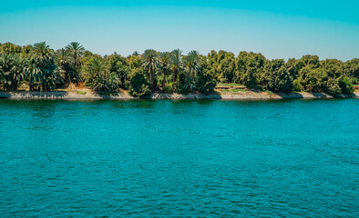 Fototapeta na wymiar Panoramic view of fertile vegetation along the banks of the Nile River near Edfu, Egypt