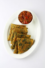 Thepla Indian flat bread,Methi Paratha,an Indian flatbread stuffed with fenugreek leaves and spices served with yogurt mango pickle & tomato chutney
in breakfast or brunch .
