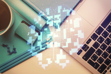 Fototapeta premium Multi exposure of data drawing hologram over topview of study desk background with computer. Concept of technology.