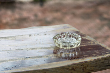The ashtray is placed on a wooden table