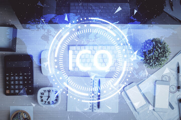 Blockchain theme hologram drawings over computer on the desktop background. Top view. Multi...
