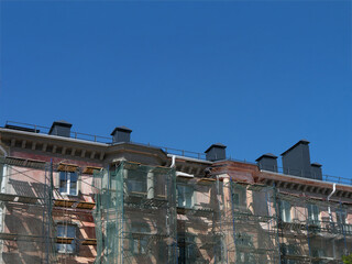 Fototapeta na wymiar Scaffolding around a building, renovating facade building.