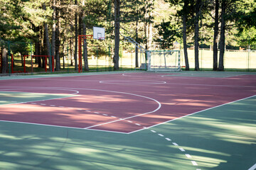 Empty football and basketball court outdoor. Public sport playground in city park.