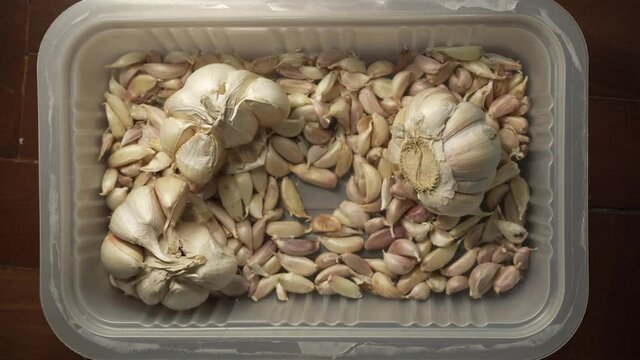 Picking and placing a garlic in a plastic box