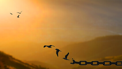 Liberty Concept. Birds fly Away Breaking Metal Chains At high mountain sunset.  Freedom, deliverance, discharge, and liberation concept  - obrazy, fototapety, plakaty