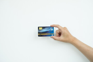 The hand holding a credit card is used for online shopping and Internet payments