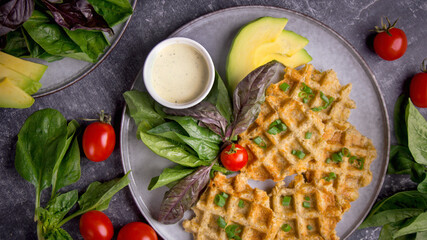 Waffles with salad, avocado and tomatoes, Top view breakfast on a dark background
