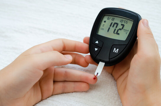 Diabetes concept - child finger with blood drop to checking blood sugar level - Powered by Adobe