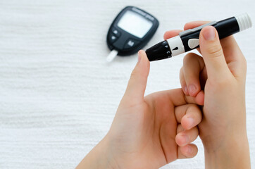 Diabetes and Glycemia. Blood sugar testing, child finger lancet punctures.