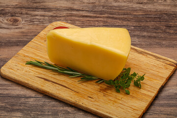 Hard cheese piece served rosemary