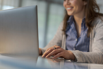 Fototapeta premium Office worker typing on a laptop