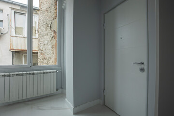 Marble corridor with entrance apartment door