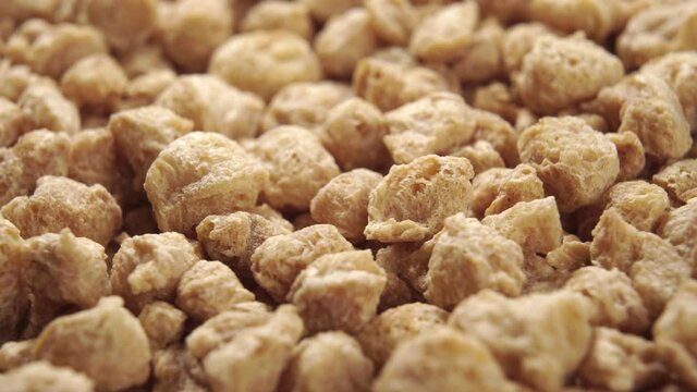 Raw soy flakes. Extreme close-up. Macro shot. Rotation. Meat substitute