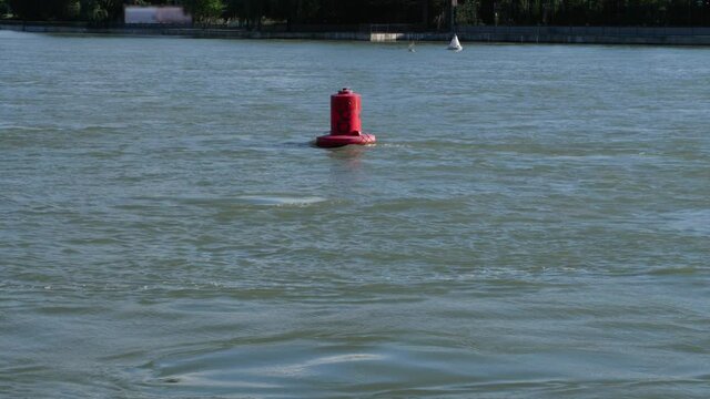 Red and white navigation buoys in the Kuban River in Krasnodar. Static shot of a flying seagull