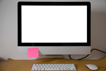 White blank computer screen in the office with sticky note. Mock up. 