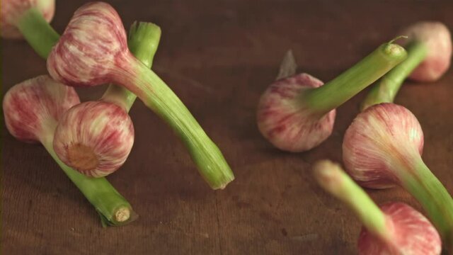 Super slow motion garlic falls on a wooden table. Filmed on a high-speed camera at 1000 fps.High quality FullHD footage