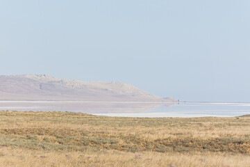 Koyash pink lake in the Crimea in the summer. Amazing delicate pastel landscape. The concept of relaxation, tranquility, and peace. Natural background in light neutral shades for design, layouts.