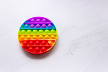 Colorful anti-stress pop it toy with round shape. Develops fine motor skills of the hands. Free...