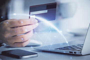 Multi exposure of woman on-line shopping holding a credit card and social network theme drawing....