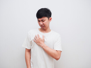 Asian man touch at his chest unhappy face on white background pain concept