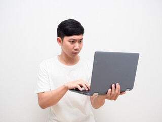 Asian man white shirt hold laptop and touch keypad with serious face on white background