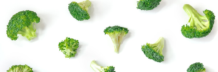 Broccoli panorama. Raw broccoli florets, shot from the top on a white background in a flat lay...