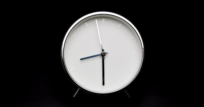 silver clock isolated on black background, Time starts walking at 8 o'clock, Time lapse 7 hour.
