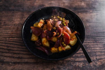 vegan roasted potatoes and beetrrot wedges with onion sauce, healthy plant-based food