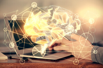 Double exposure of man's hand holding and using a digital device and brain hologram drawing. Data concept.