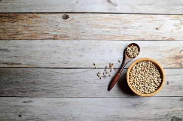 Top Views of Black-eyed white beans  (cow Peas) in a wooden bowl and wooden spoon isolated on the wooden background, Healthy Food Concept.