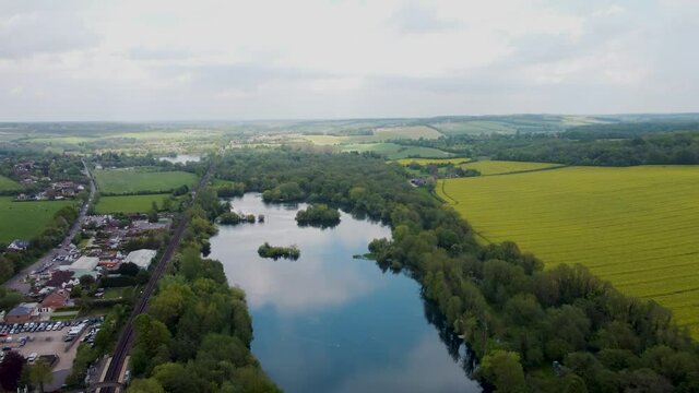 Aerial footage flying over a lake on Chilham, Kent, UK