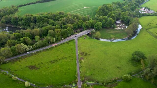 Aerial footage of green fields and country roads