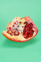 Pomegranate closeup, macro, colored backdrop