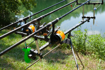Close up of fishing rods on holder by the lake, ready for fishing