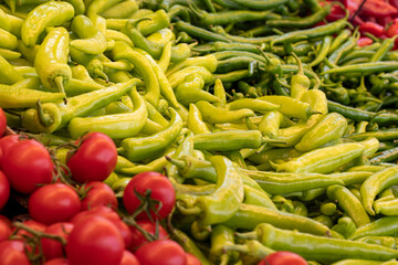 Varieties of vegetables sold at the grocery store. Tomatoes, peppers. Food background