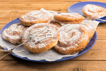Spanish Ensaimadas spiral pastry on rustic table