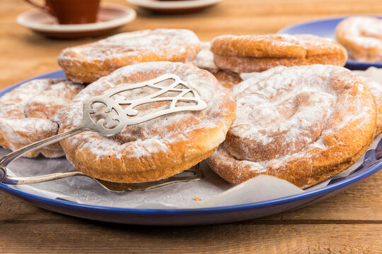 Ensaimadas, spanish spiral pastry on coffee table closeup
