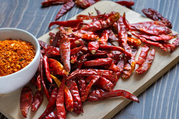 Dry red chili on plate wood , Cayenne pepper in white ceramic bowl