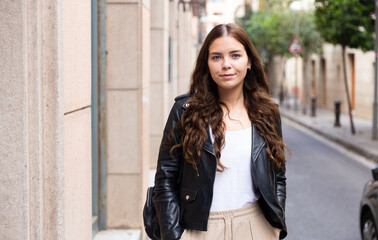 Portrait of an elegant woman on summer street of european city