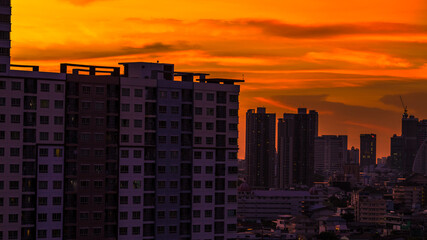 The blurred abstract background of the morning sun exposure to the tiny dust particles that surround the tall buildings in the capital, the long-term health issue of pollution