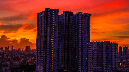 The high angle background of the city view with the secret light of the evening, blurring of night lights, showing the distribution of condominiums, dense homes in the capital community