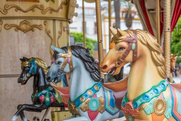 Obraz na płótnie Canvas Detailed view of colorful horses from a vintage classic carousel