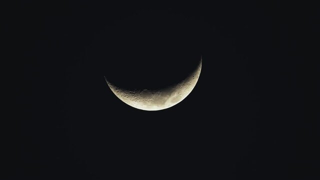 luminous crescent moon celestial body setting in night timelapse