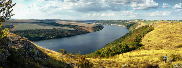 Scenic panorama view of Dnister River in Ukraine. Incredible nature landscape. Amazing autumn scenery. Majestic calm river and perfect sky  over Dnister canyon of Ukraine. Popular touristic landsmarks