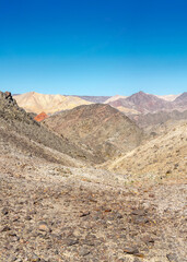 The trail goes through a rocky desert canyon.
