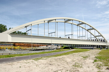 Rotterdam, The Netherlands, June 12, 2021: steel arch bridge in the harbour cargo railway line in Europoort industrial area