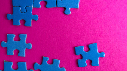 scattered puzzle pieces on colored background