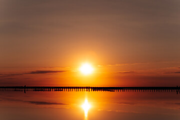 Naklejka premium pink lake and sandy beach with a sea bay under a blue sky with clouds
